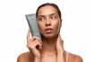 Alpha-H Clear Skin Face & Body Wash modella con il tubo accanto al viso