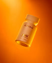 Alpha-H Liquid Gold + Vitamin C Exfoliating Treatment flacone in luce arancione
