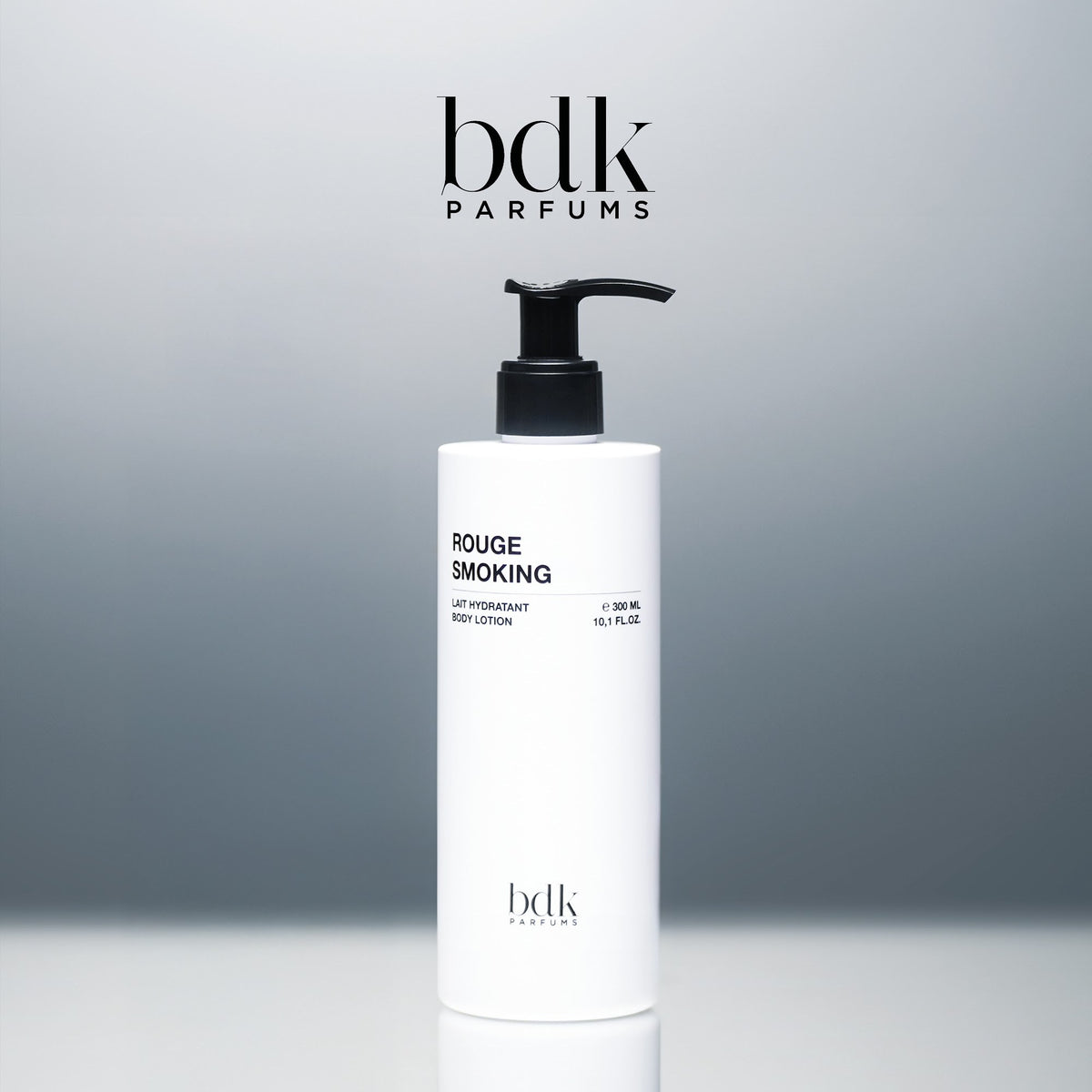 BDK Parfums Rouge Smoking Body Lotion flacone con pompa in studio con logo bdk